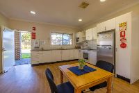 Unit 1-dining-kitchen-area-with-fridge_-dining-area-and-view-of-the-backyard