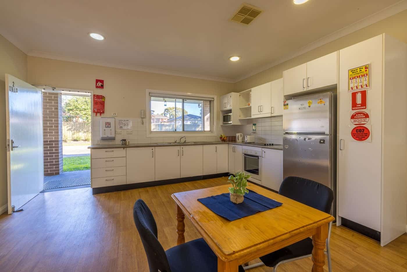 Unit 1-dining-kitchen-area-with-fridge_-dining-area-and-view-of-the-backyard