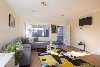 Living room-with-colourful-rug_-modern-couch-and-indoor-plants