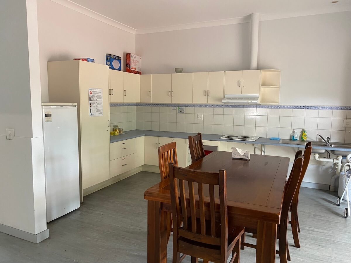 Furnished kitchen with dining set and fridge
