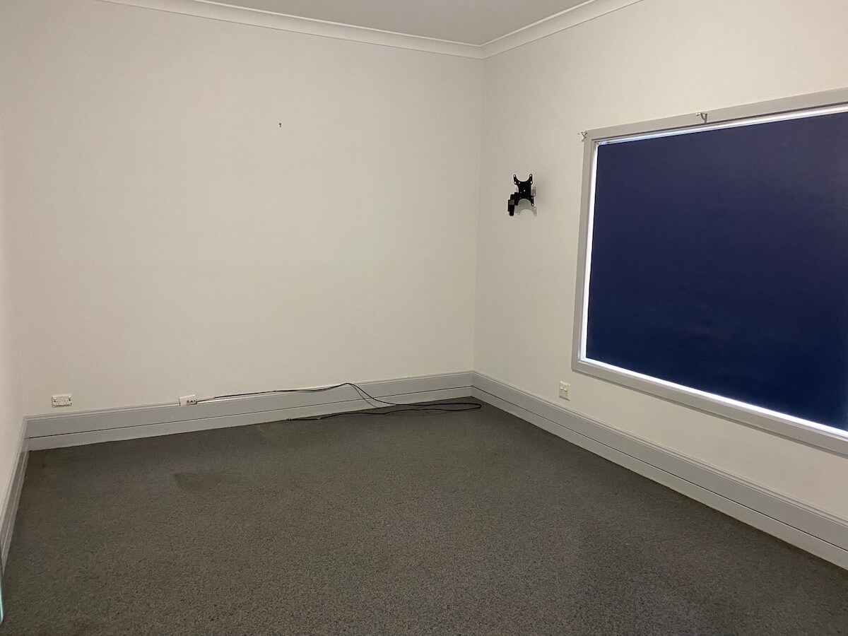 Empty bedroom with a window with blinds down