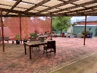 Oudoor covered seating with garden in background