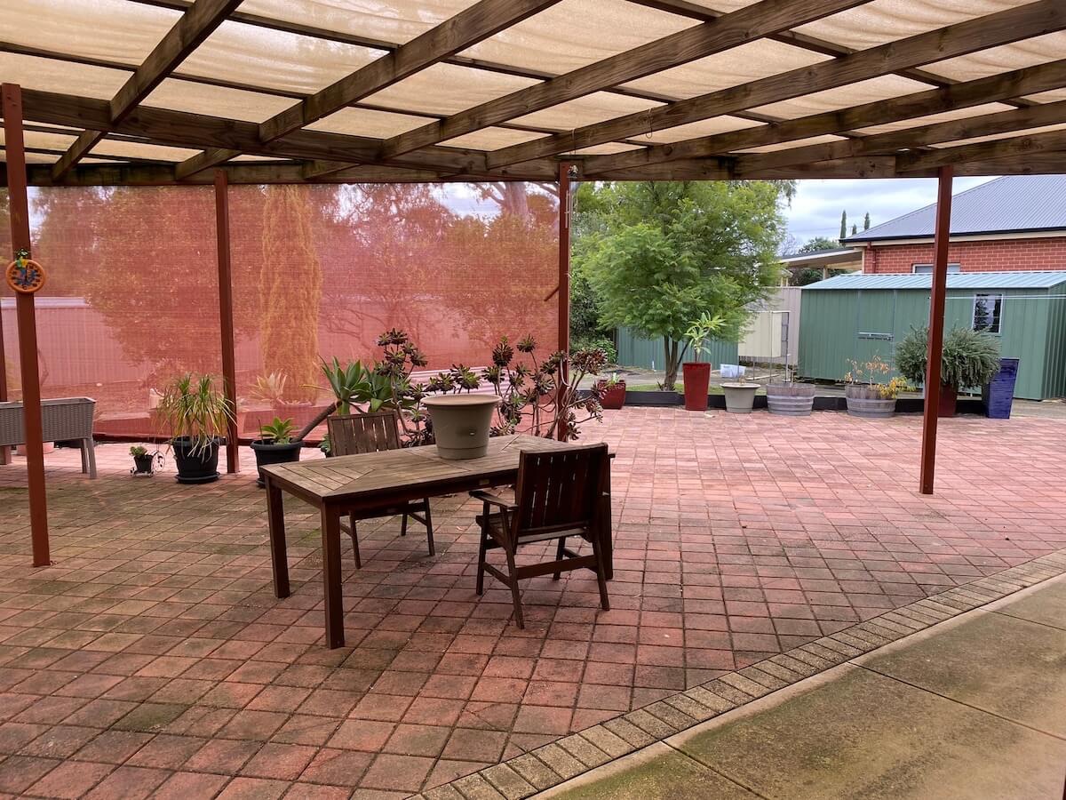 Oudoor covered seating with garden in background